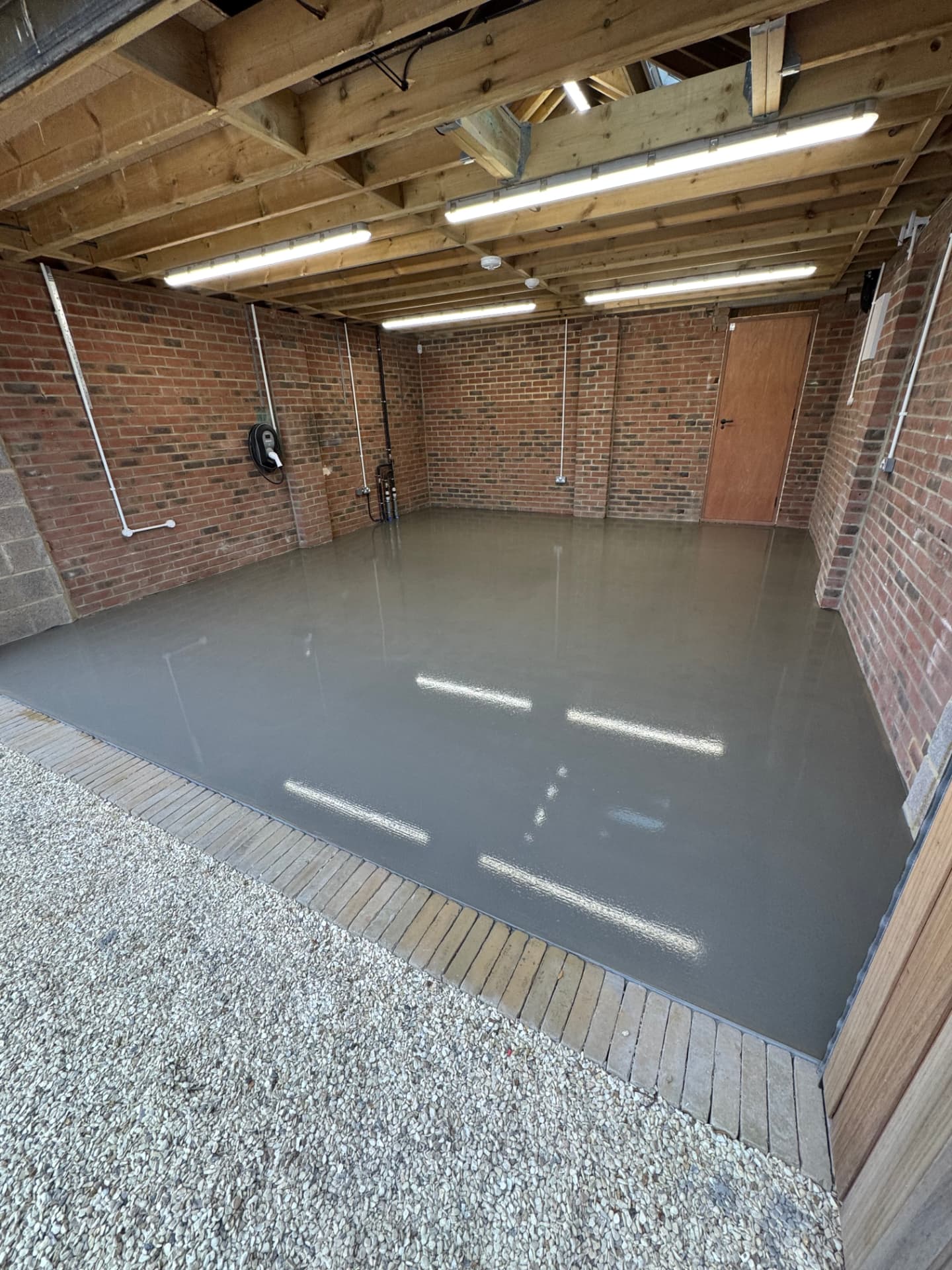 Screed floor in an exposed brick garage workshop